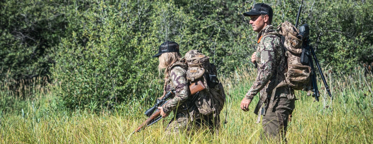 Shooter using a Horus optic in field terrain